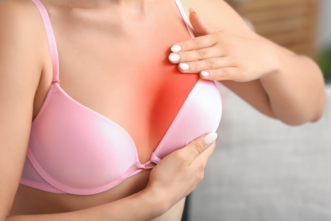 Young Woman Checking Her Breast at Home, Closeup. Cancer Awareness Concept